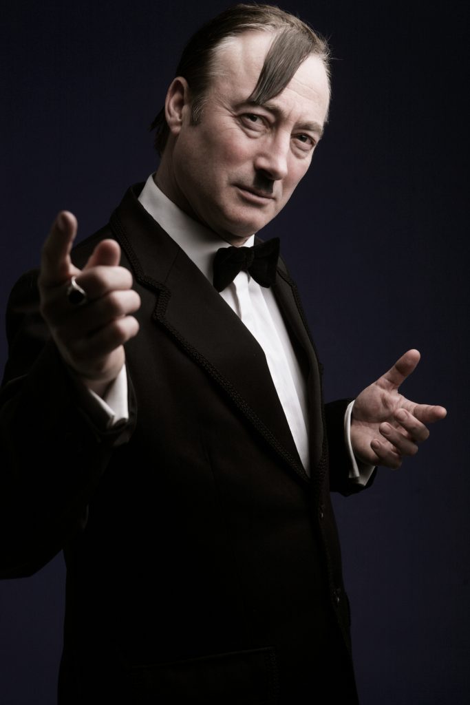 Comedy Dictator Frank Sanazi pointing towards camera | Photo credit: Patrick Ford